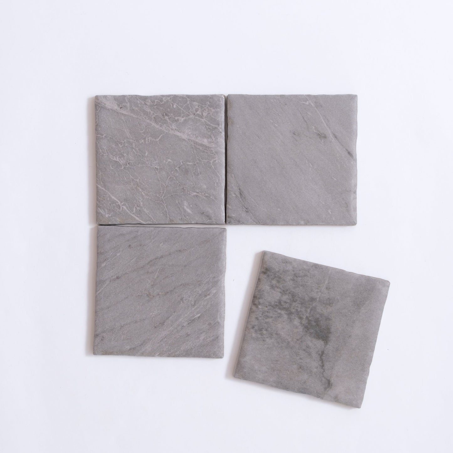 Four Tosca Bardiglio sample tiles on a white background, with one tile slightly separated from the group.