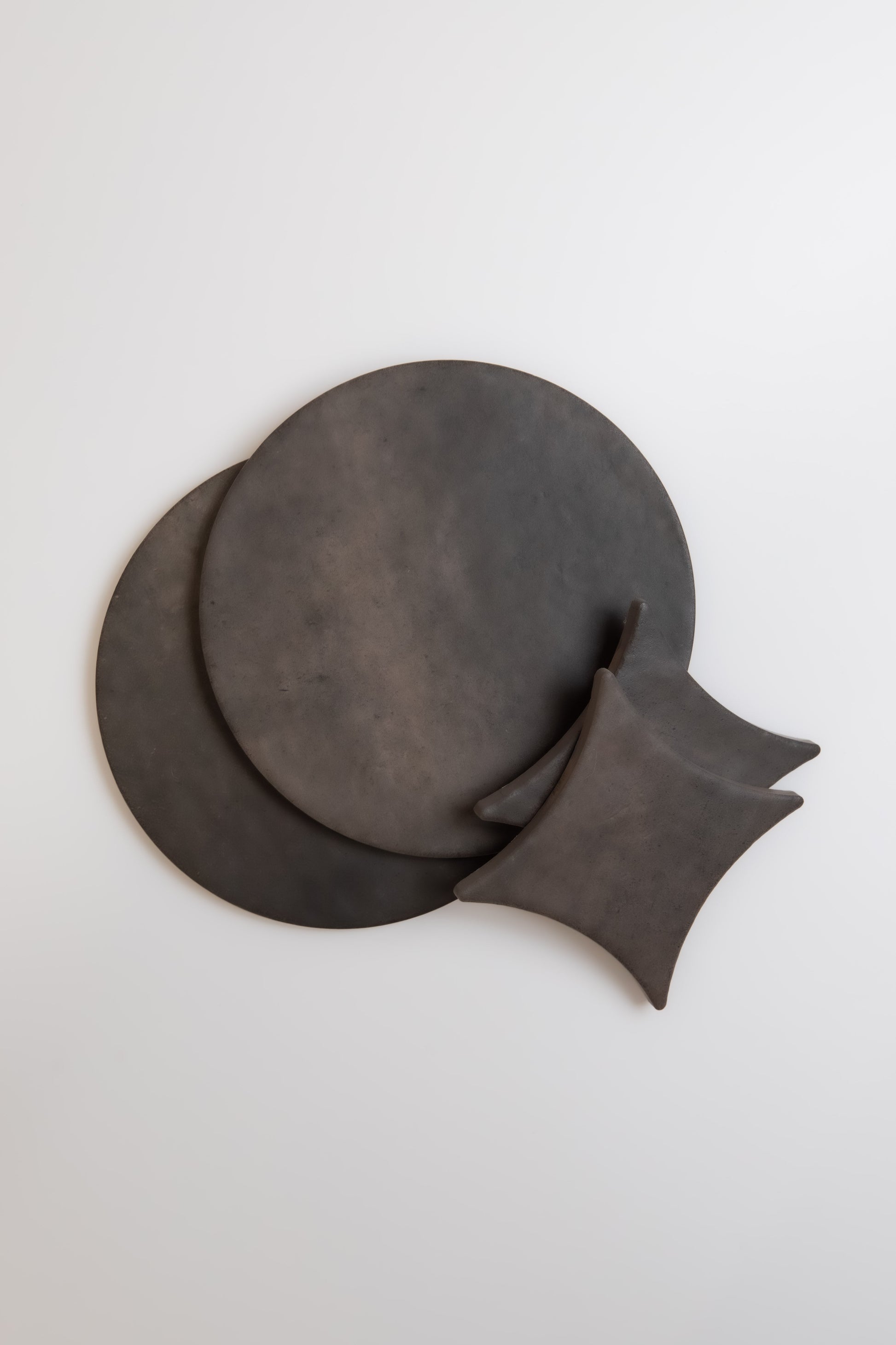 Two round and two square Finca Black Horse, Extra Sample trays overlap on a plain white background.