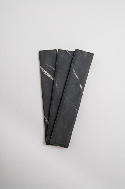 Three Tosca Black Marble, Extra Sample pieces with white streaks are arranged side by side on a plain background.