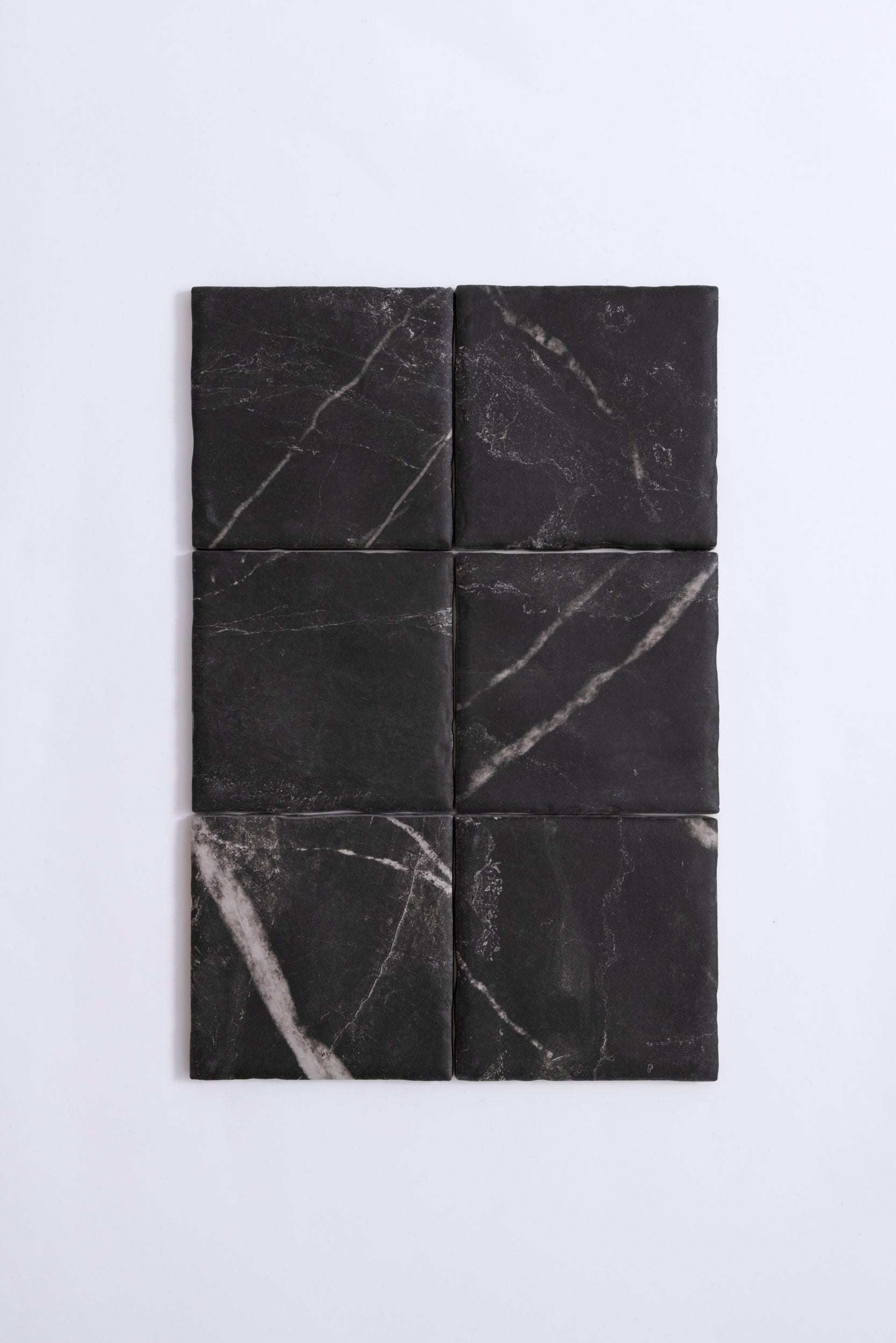 Six Tosca Black Marble, Extra Sample tiles with white veining, arranged in two columns on a plain white background.