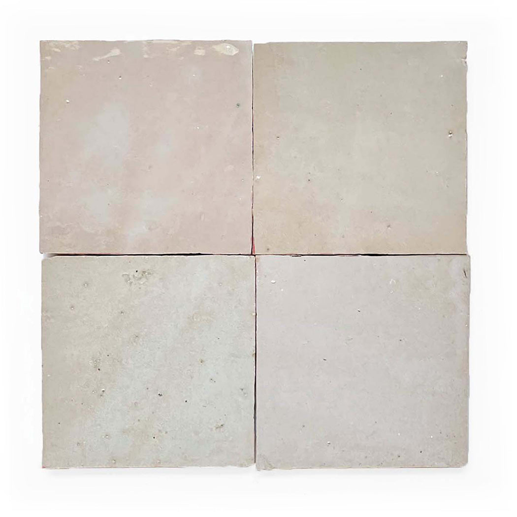 Four square, light beige tiles arranged in a 2x2 grid on a white background.