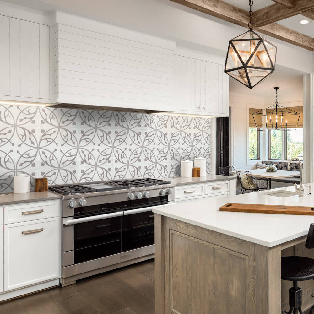 Modern kitchen with New York Cement Tile N20-019 backsplash, white cabinets, wood island, and geometric pendant light.