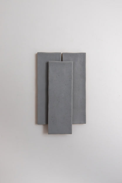 Three Bourton Dark Blue tiles by Cottage Ivy are stacked vertically, overlapping on a plain white background.