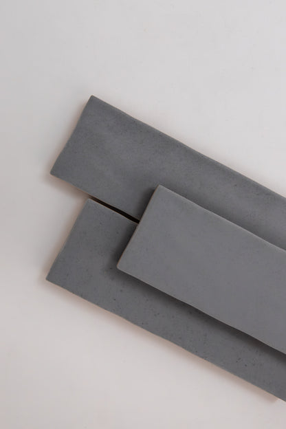Three overlapping Bourton Dark Blue sample tiles by Cottage Ivy on a light, neutral background.