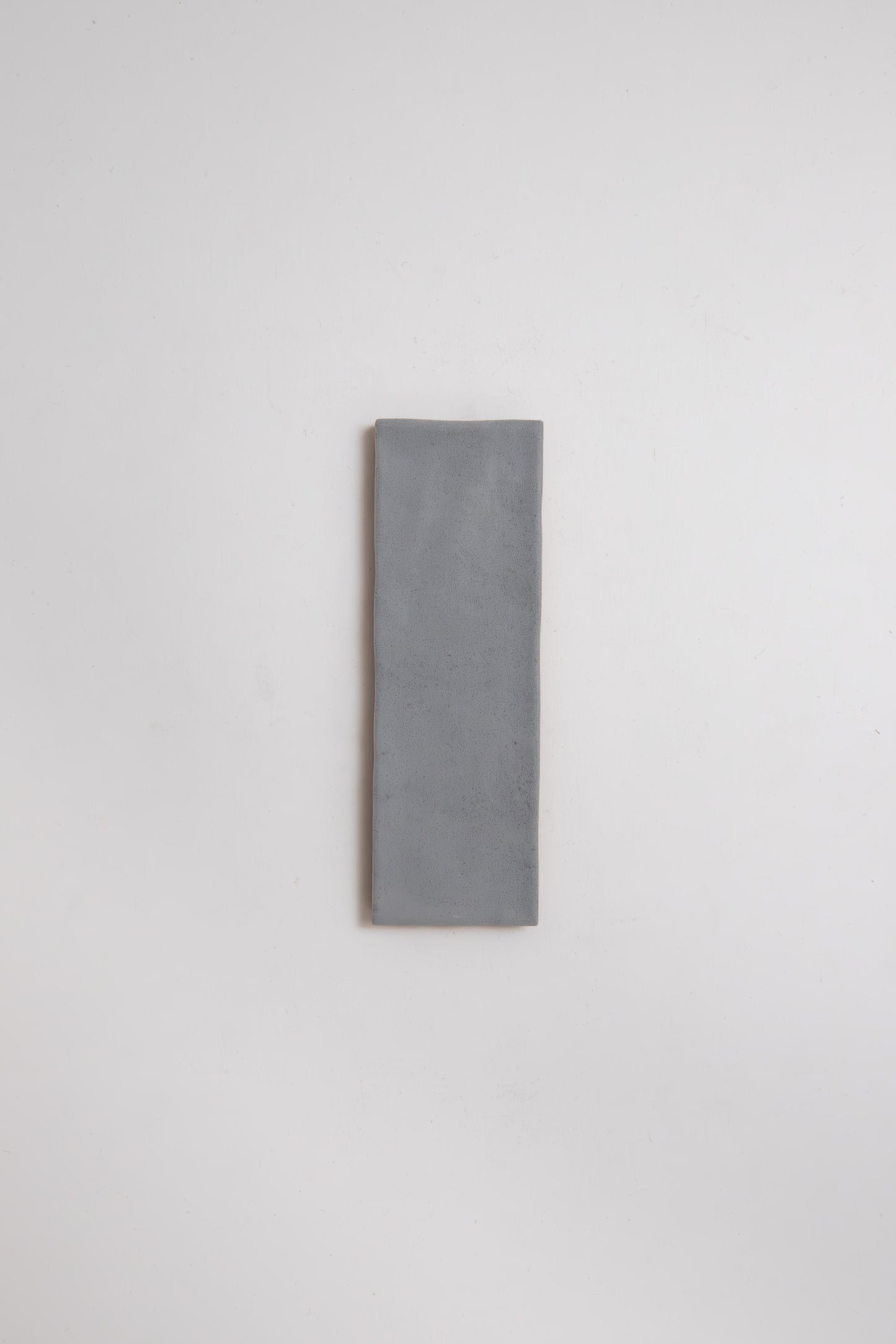 A single Bourton Dark Blue tile sample by Cottage Ivy is centered on a plain white background.