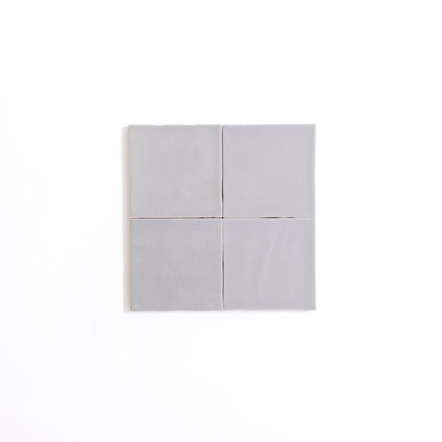Four Bourton Dark Blue tiles by Cottage Ivy arranged 2x2 on a plain white background.