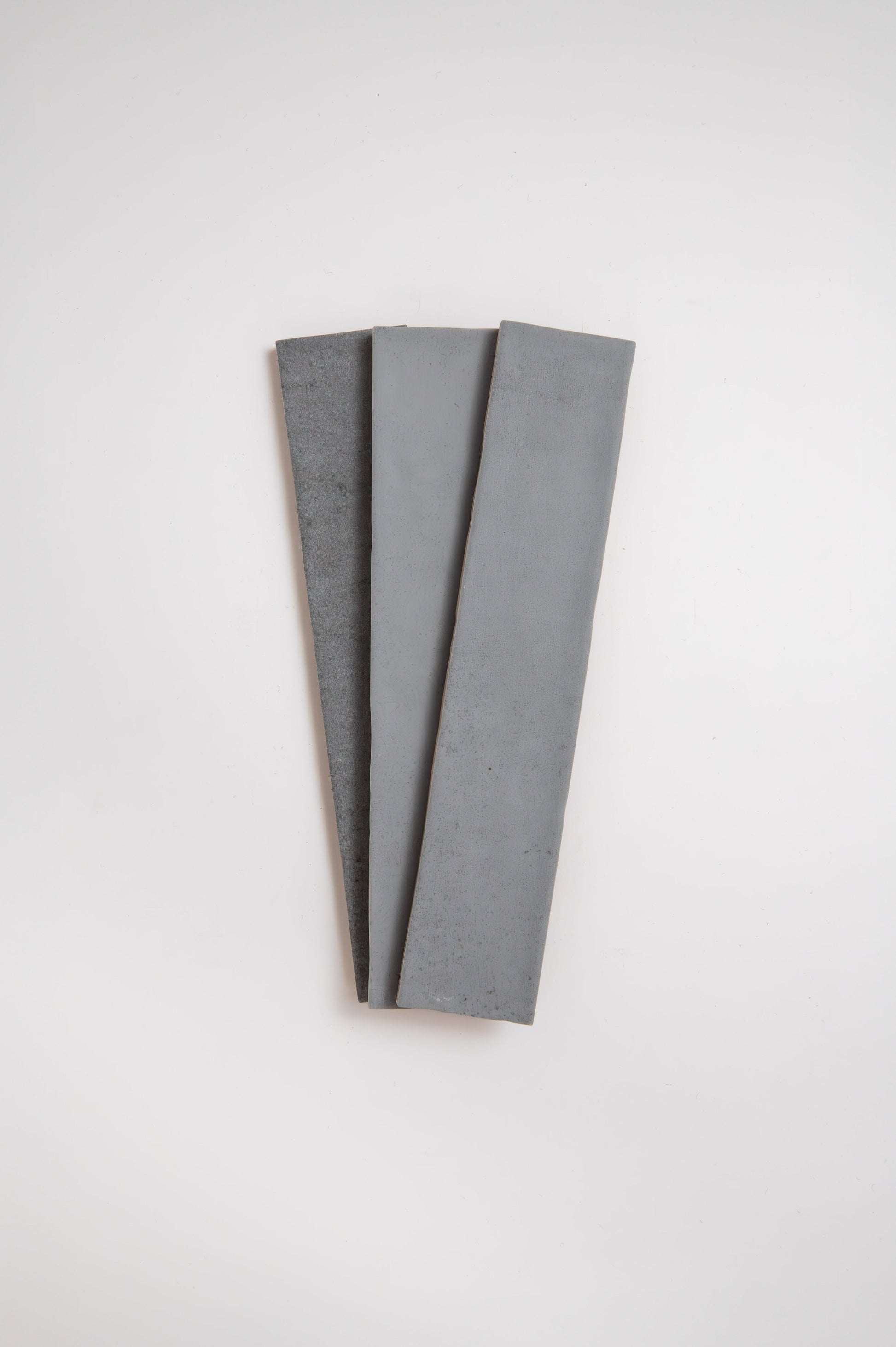 Three Bourton Dark Blue tiles by Cottage Ivy, arranged side by side on a white background.
