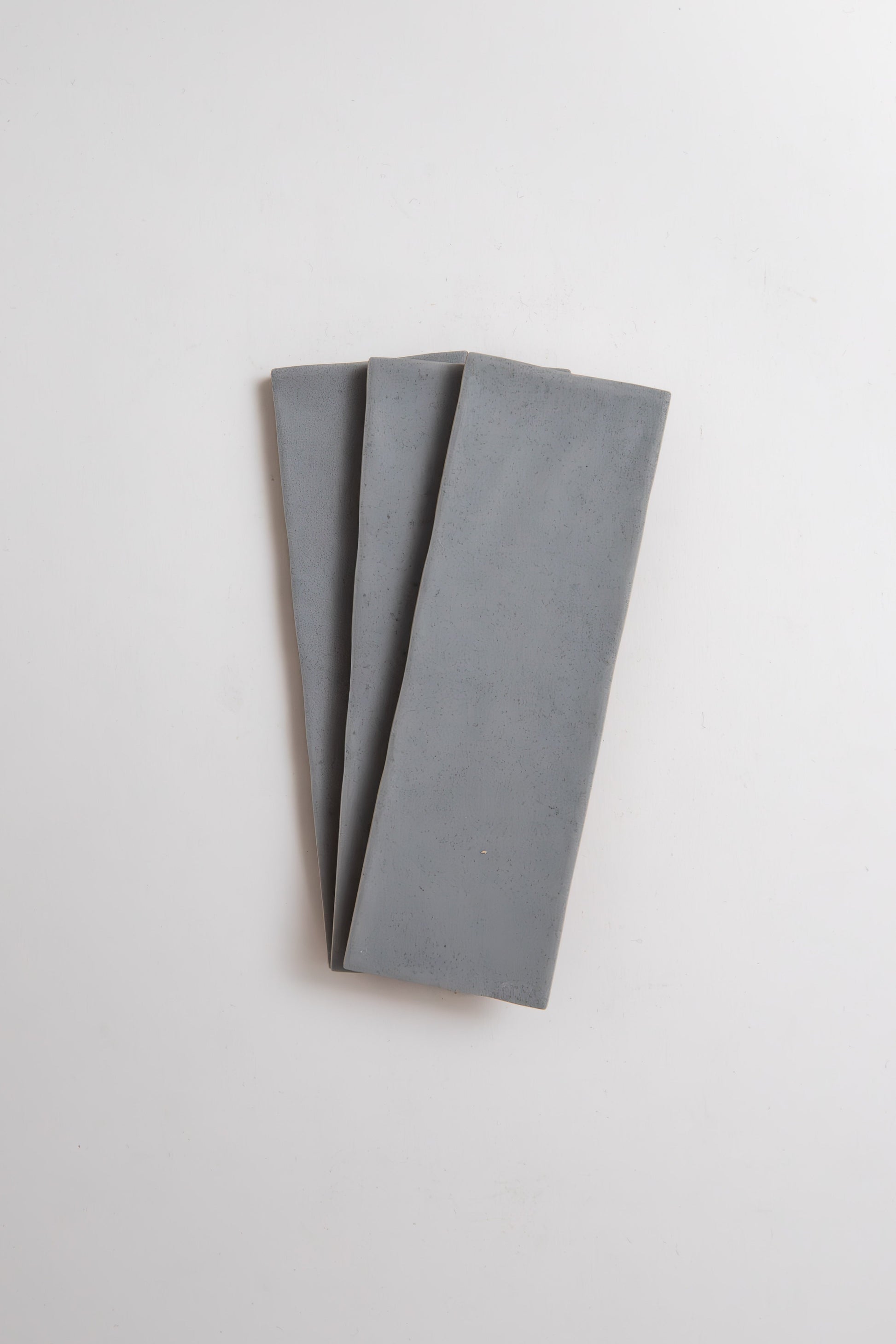 Three Bourton Dark Blue Extra Sample slabs by Cottage Ivy, arranged fan-shaped on a white background.