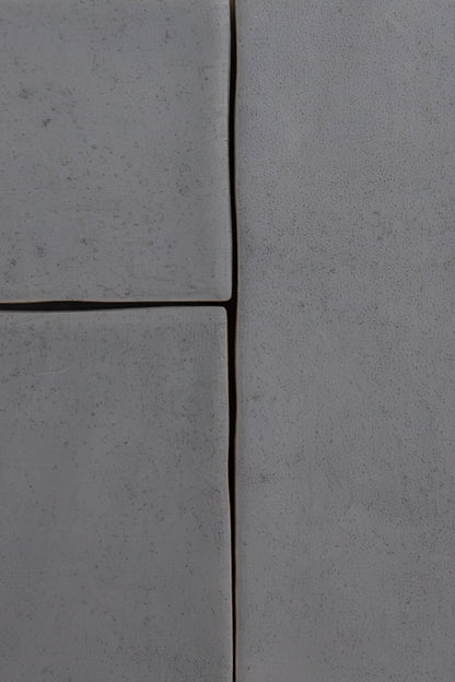 Close-up of four Bourton Dark Blue tiles by Cottage Ivy, showing textured surfaces, uneven edges, and thin dark gaps.