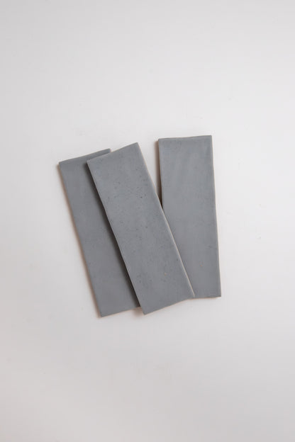 Three Bourton Dark Blue slabs by Cottage Ivy, overlapping on a white background.