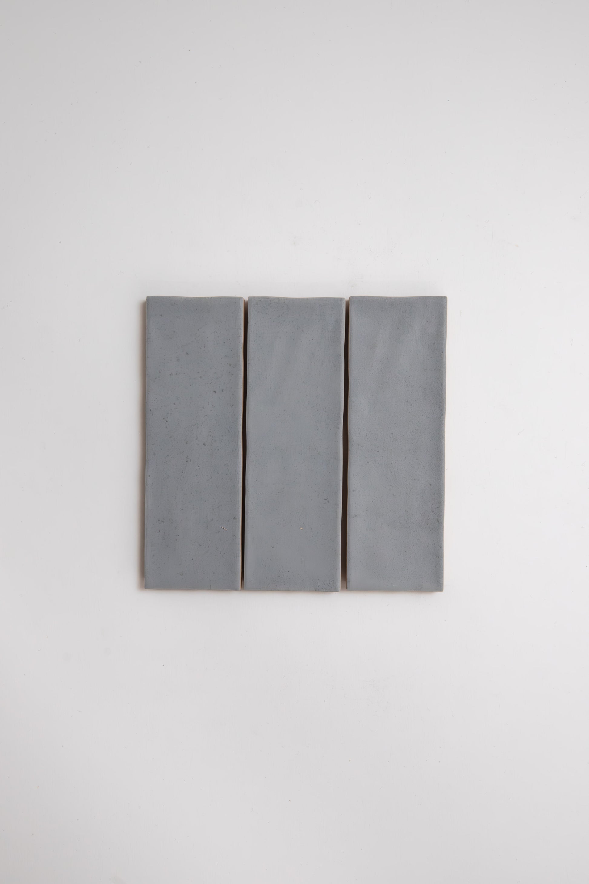 Three Bourton Dark Blue tiles by Cottage Ivy are aligned vertically side by side against a plain white background.