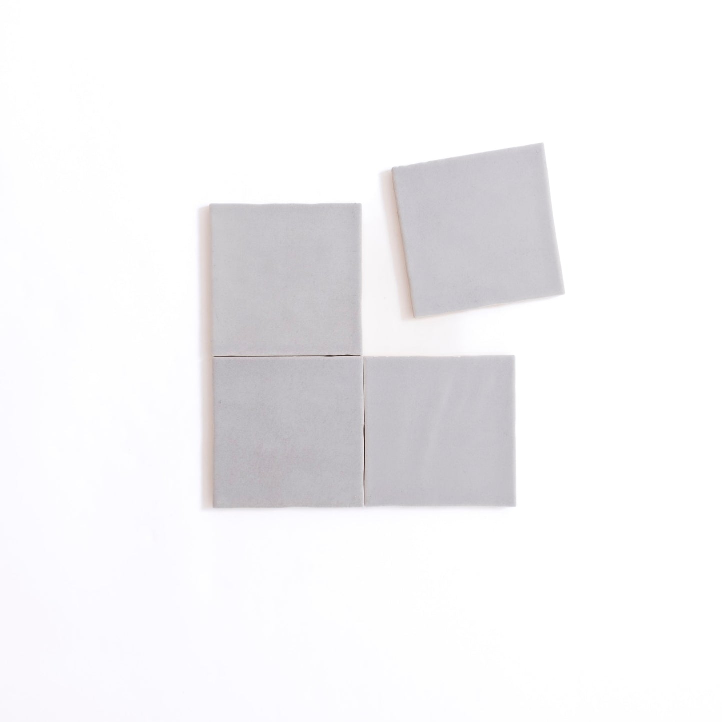 Four Bourton Dark Blue Extra Sample tiles by Cottage Ivy, with one tile set slightly apart above the others.
