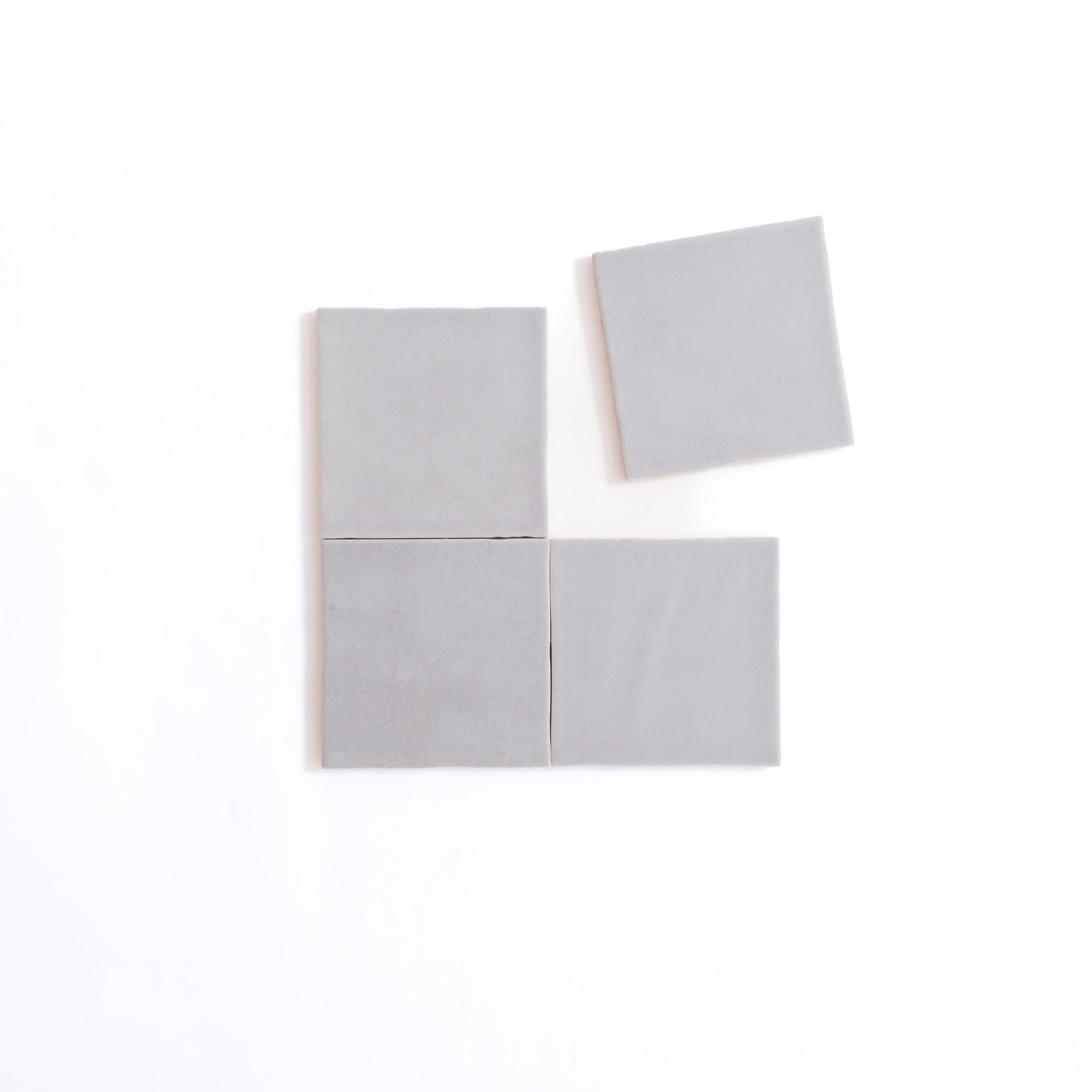 Four Bourton Dark Blue Extra Sample tiles by Cottage Ivy, with one tile set slightly apart above the others.