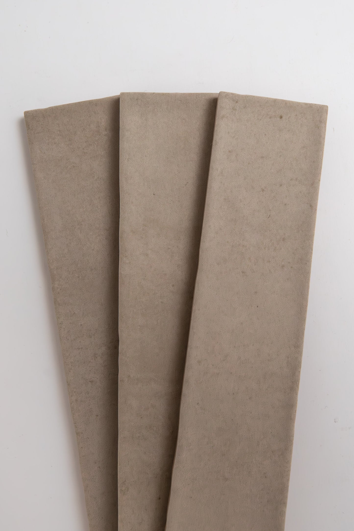 Three Buckland Beige samples by Cottage Ivy are laid side by side on a white background.