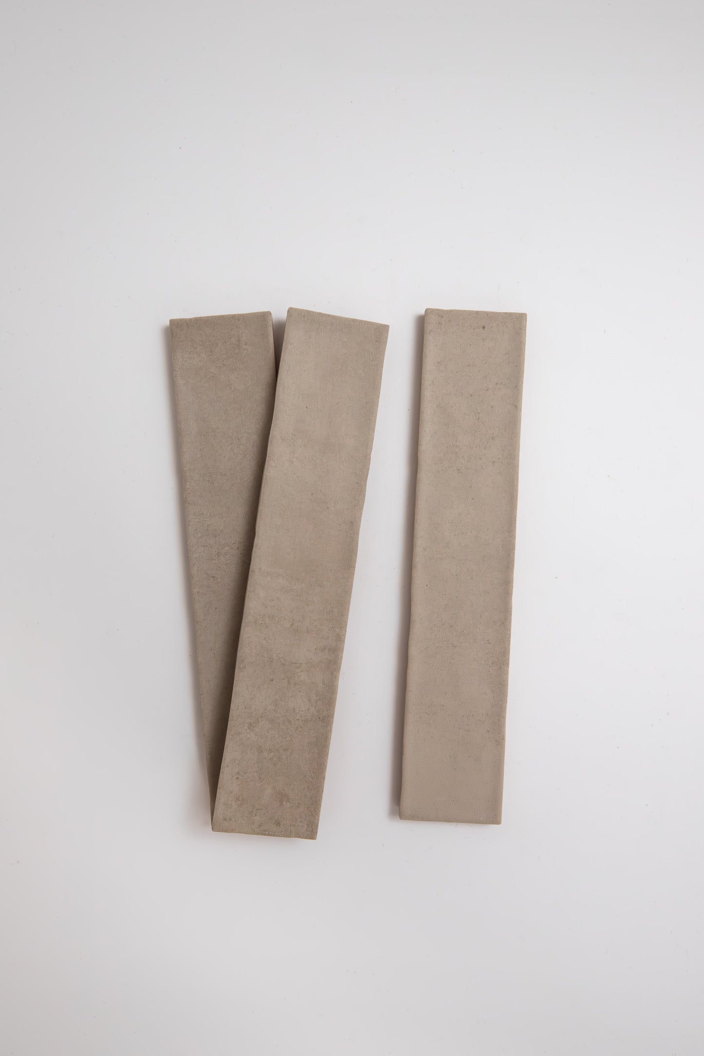 Three Buckland Beige sample tiles by Cottage Ivy are arranged diagonally on a plain white background.