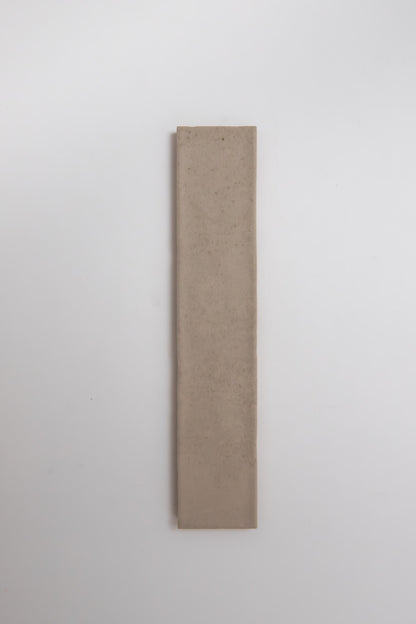 A single Buckland Beige tile sample by Cottage Ivy is placed vertically on a plain white background.