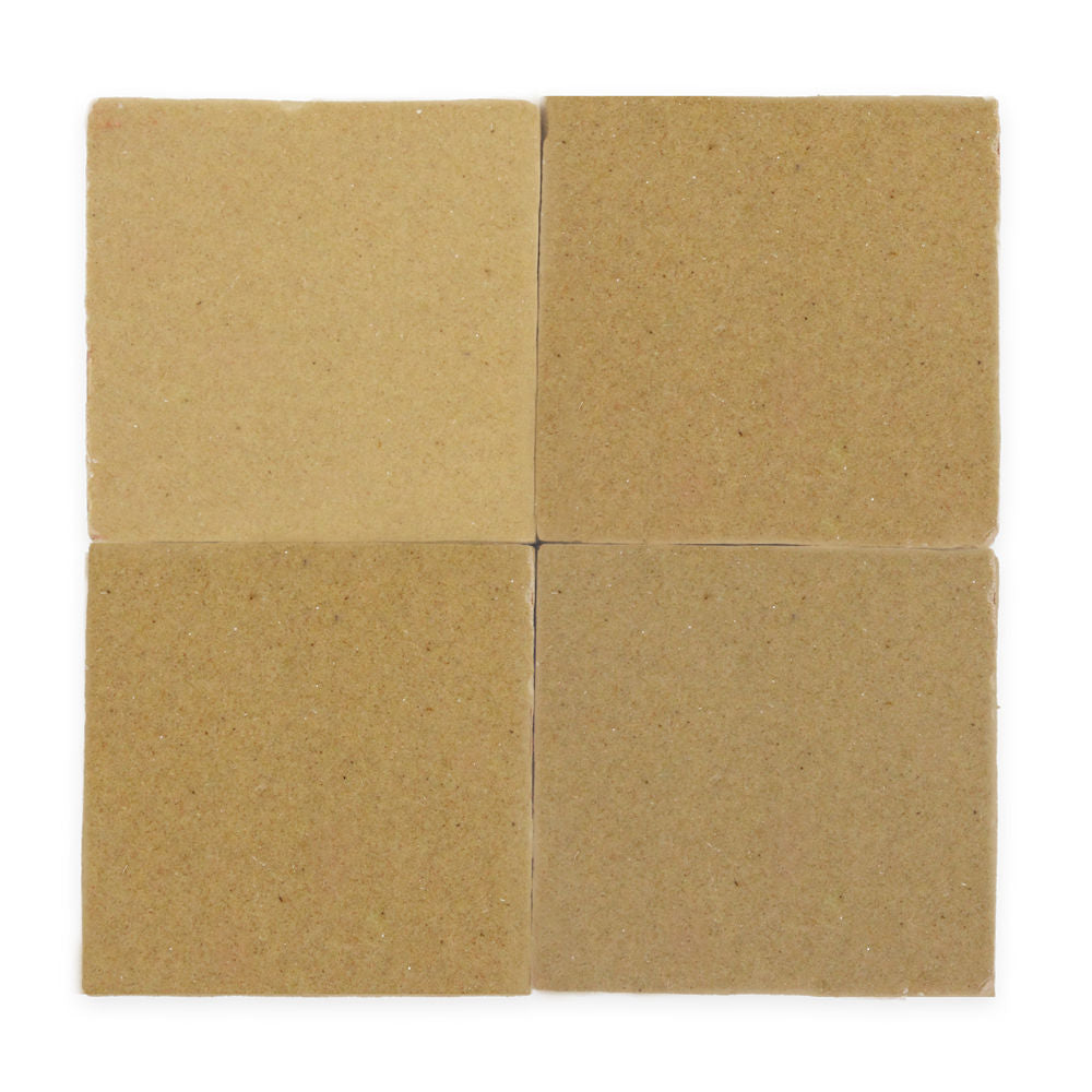 Four square, beige ceramic tiles arranged in a 2x2 grid on a white background.