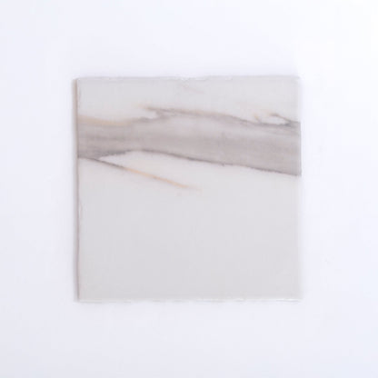 Nine Calacatta Gold marble tiles by New York Cement Tile arranged in a 3x3 grid on a plain white background.