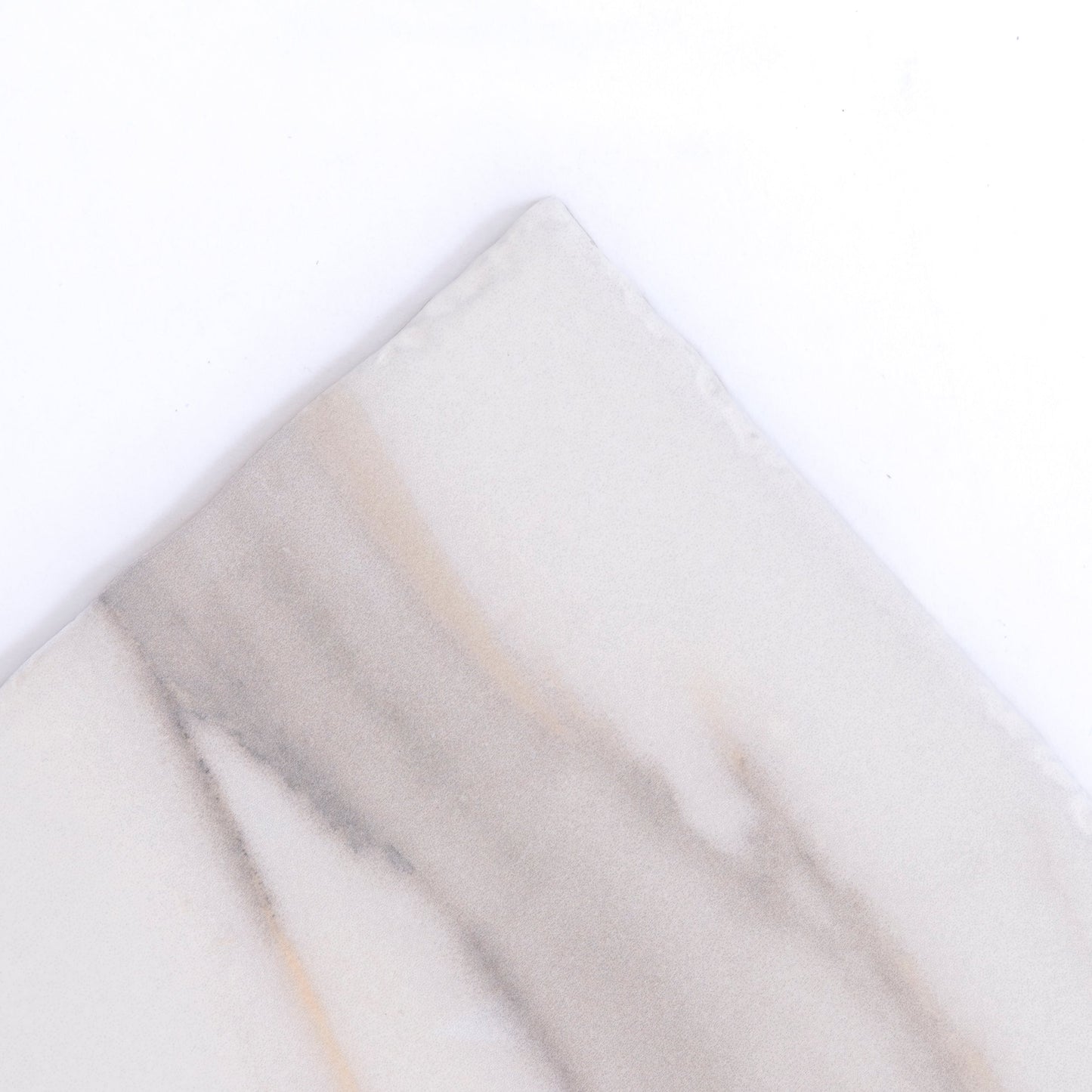Calacatta Gold by New York Cement Tile: a square white tile with a diagonal gray and beige streak on top half.