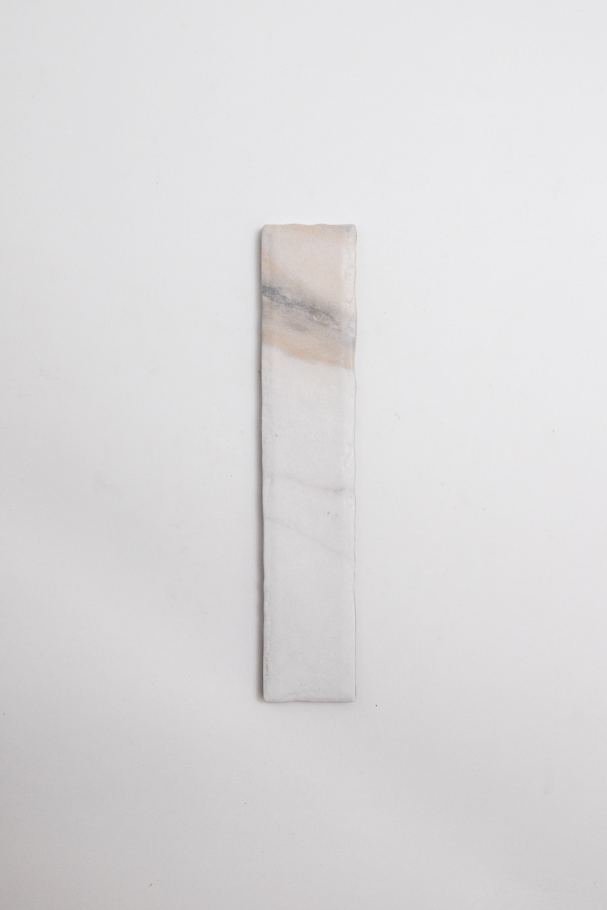 Tosca Calacatta Gold: a rectangular white stone with subtle beige and gray veining on a plain background.