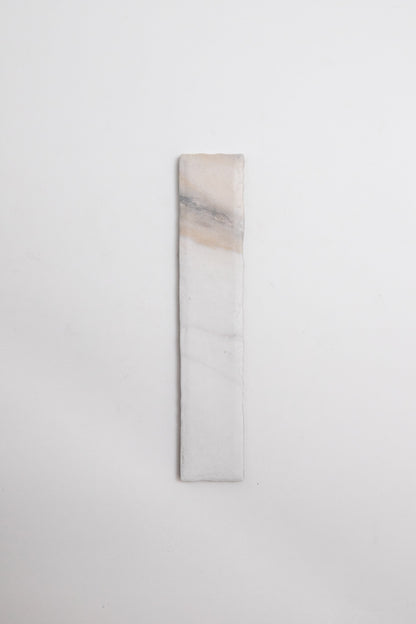 Tosca Calacatta Gold: a rectangular white stone with subtle beige and gray veining on a plain background.