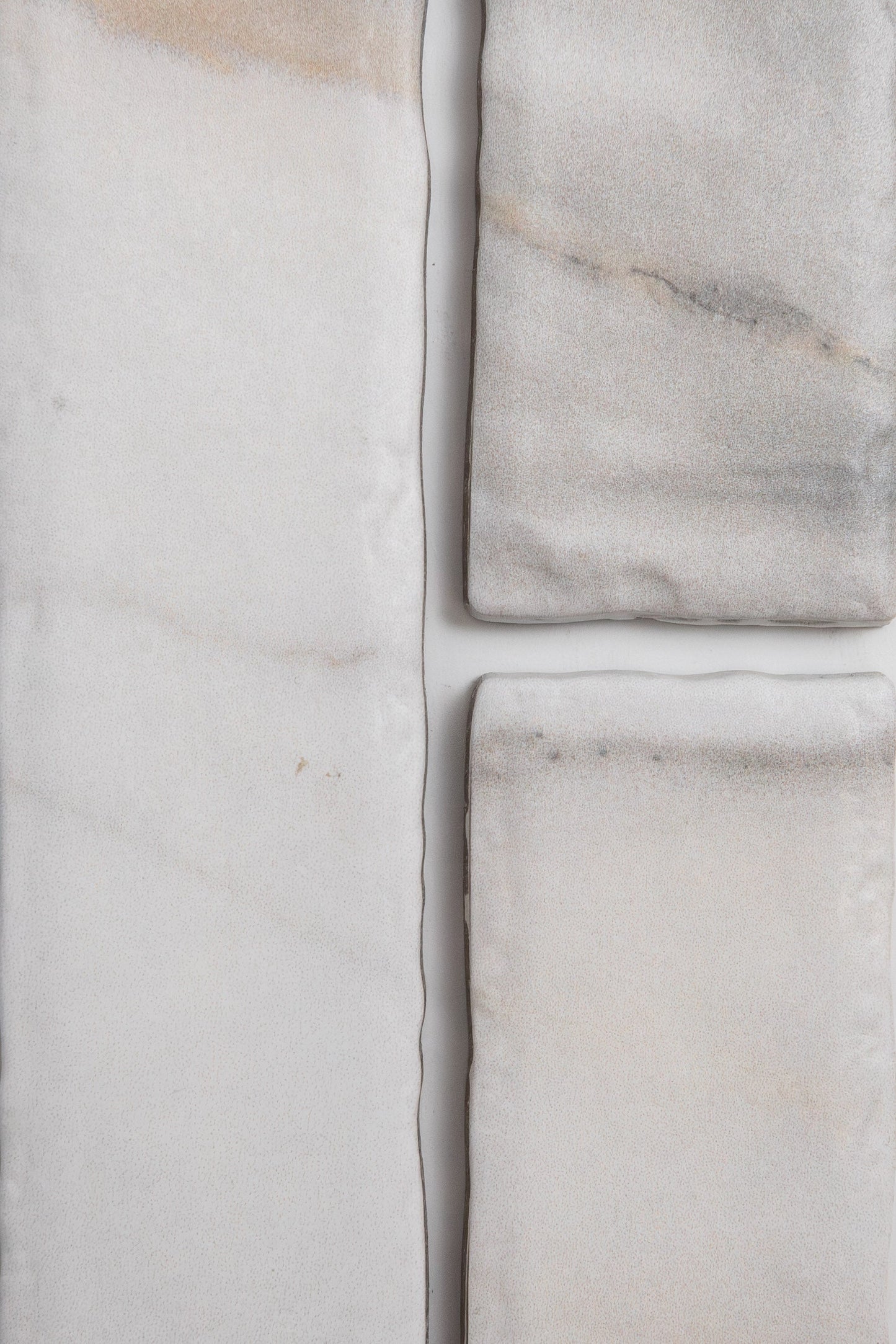 Four Tosca Calacatta Gold marble pieces with subtle veins, arranged on a white background.