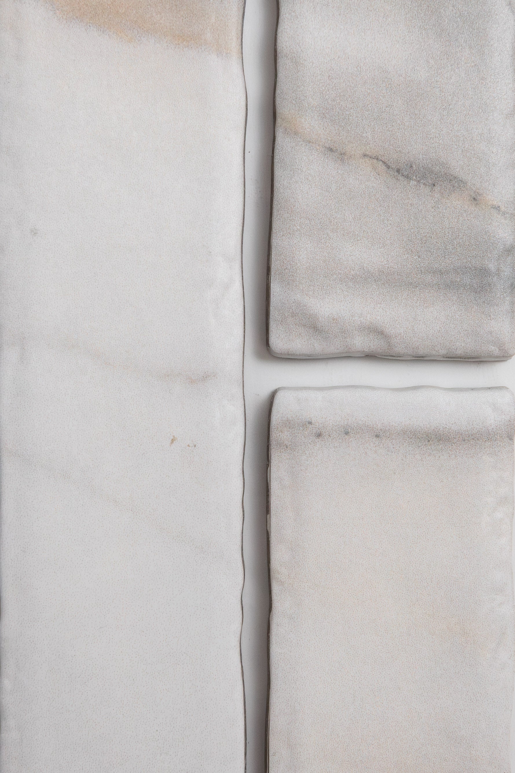 Four Tosca Calacatta Gold marble pieces with subtle veins, arranged on a white background.