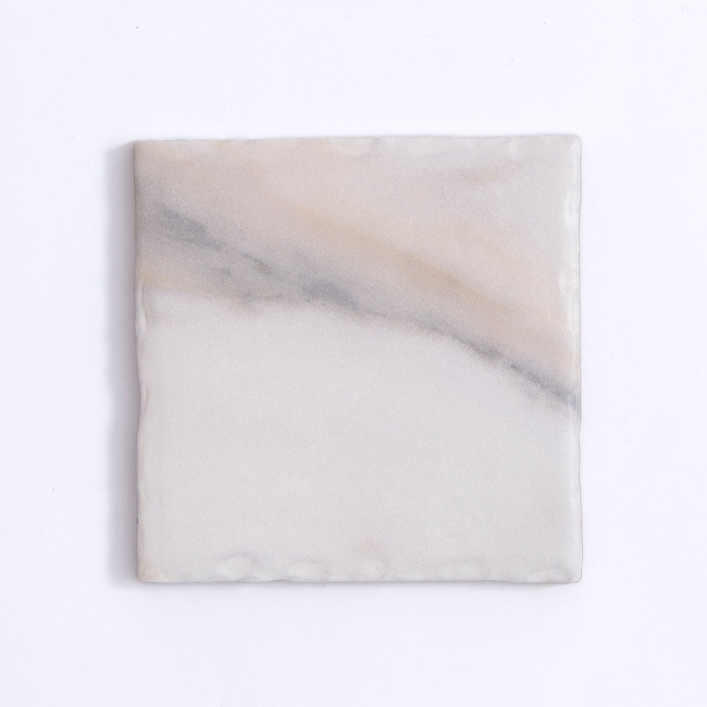 Tosca Calacatta Gold tile features subtle gray diagonal veins on a white marble background.