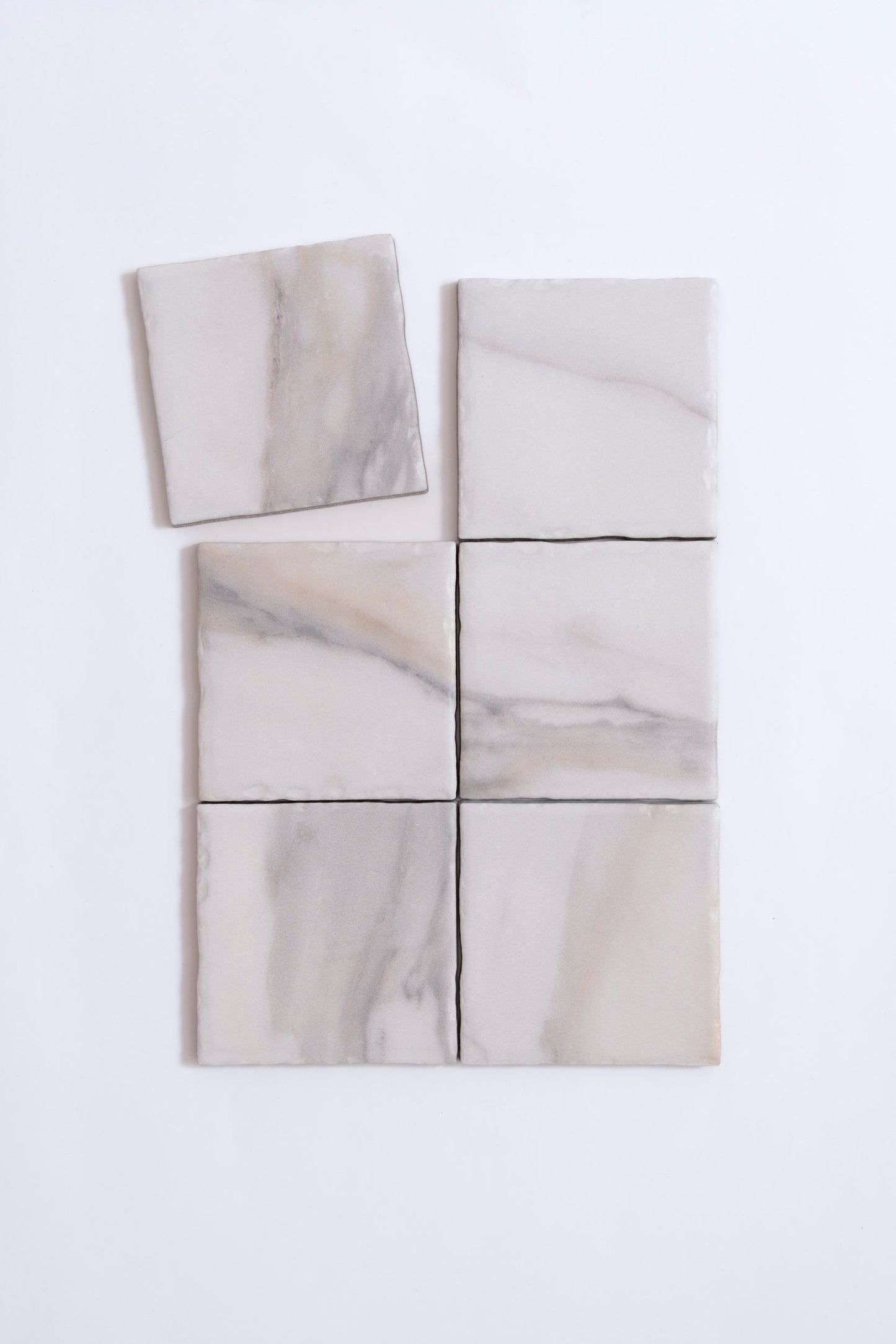 Six Tosca Calacatta Gold, Extra Sample tiles in a grid on white; one tile is slightly askew.