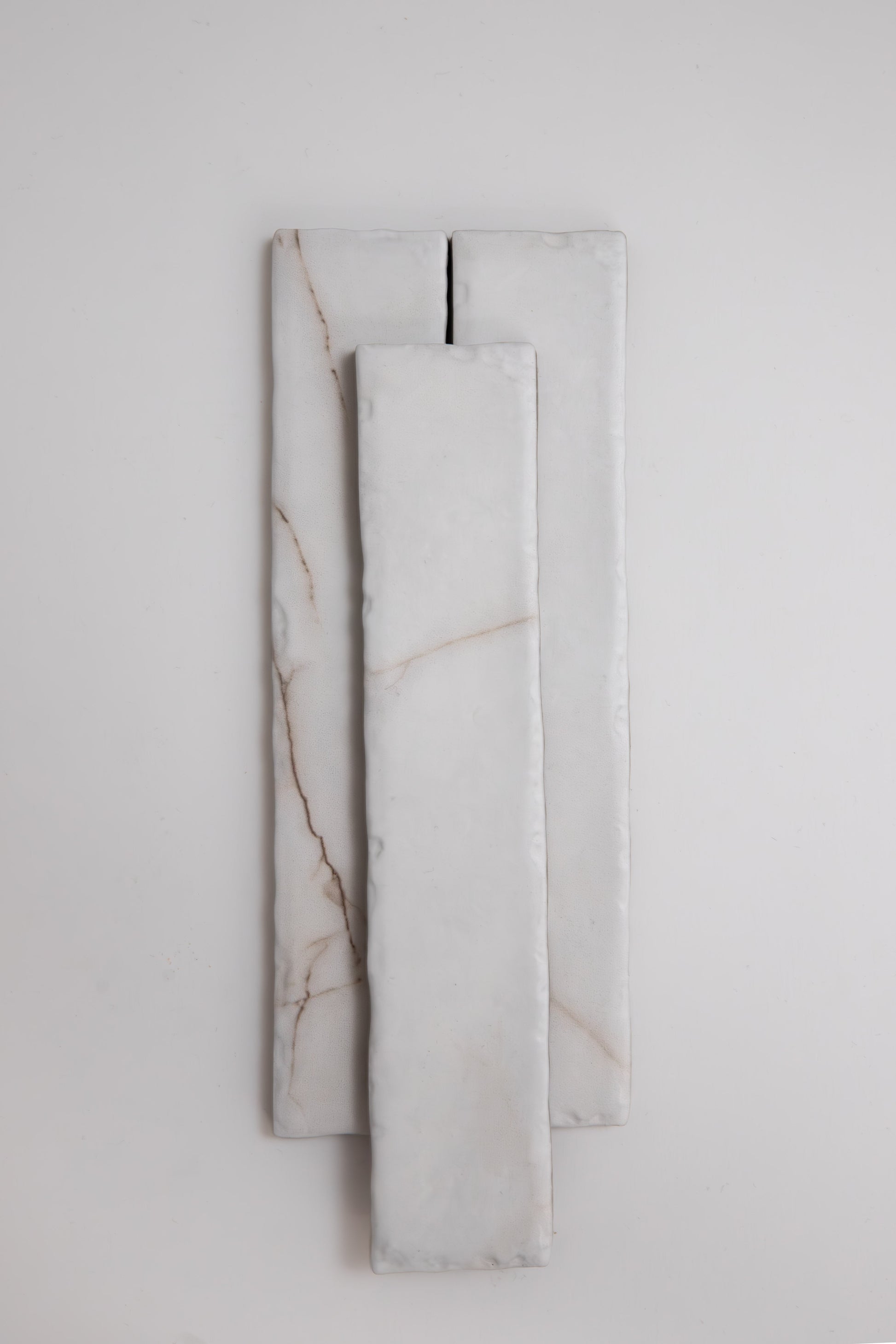 Three rectangular Tosca Calacatta Soft marble samples with subtle brown veins, stacked on a light background.