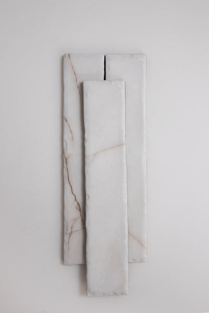 Three rectangular Tosca Calacatta Soft marble samples with subtle brown veins, stacked on a light background.