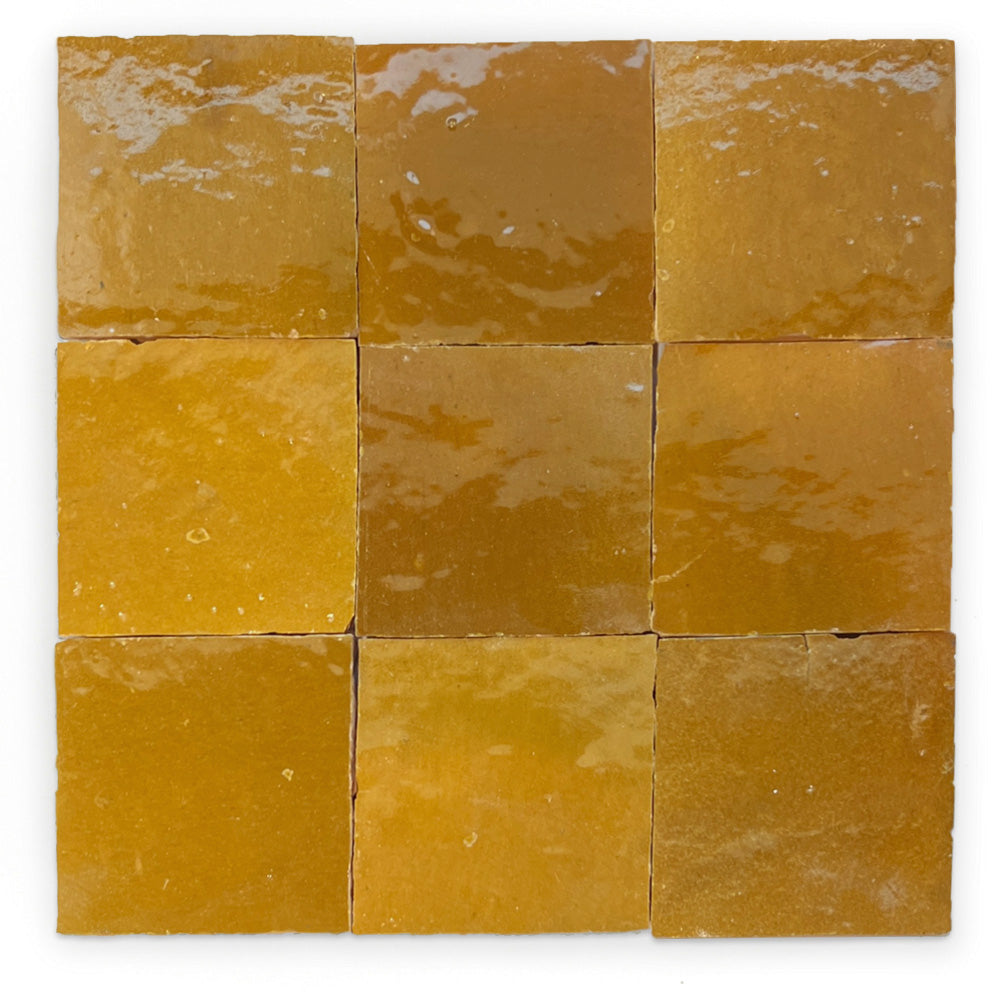 Nine Caramel Glazed tiles by New York Cement Tile form a glossy, square three-by-three grid in mustard yellow.