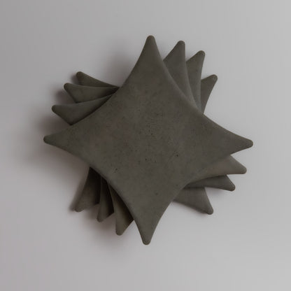 Finca Cardon, Extra Sample—gray, diamond-shaped pieces stacked at an angle on a white background.