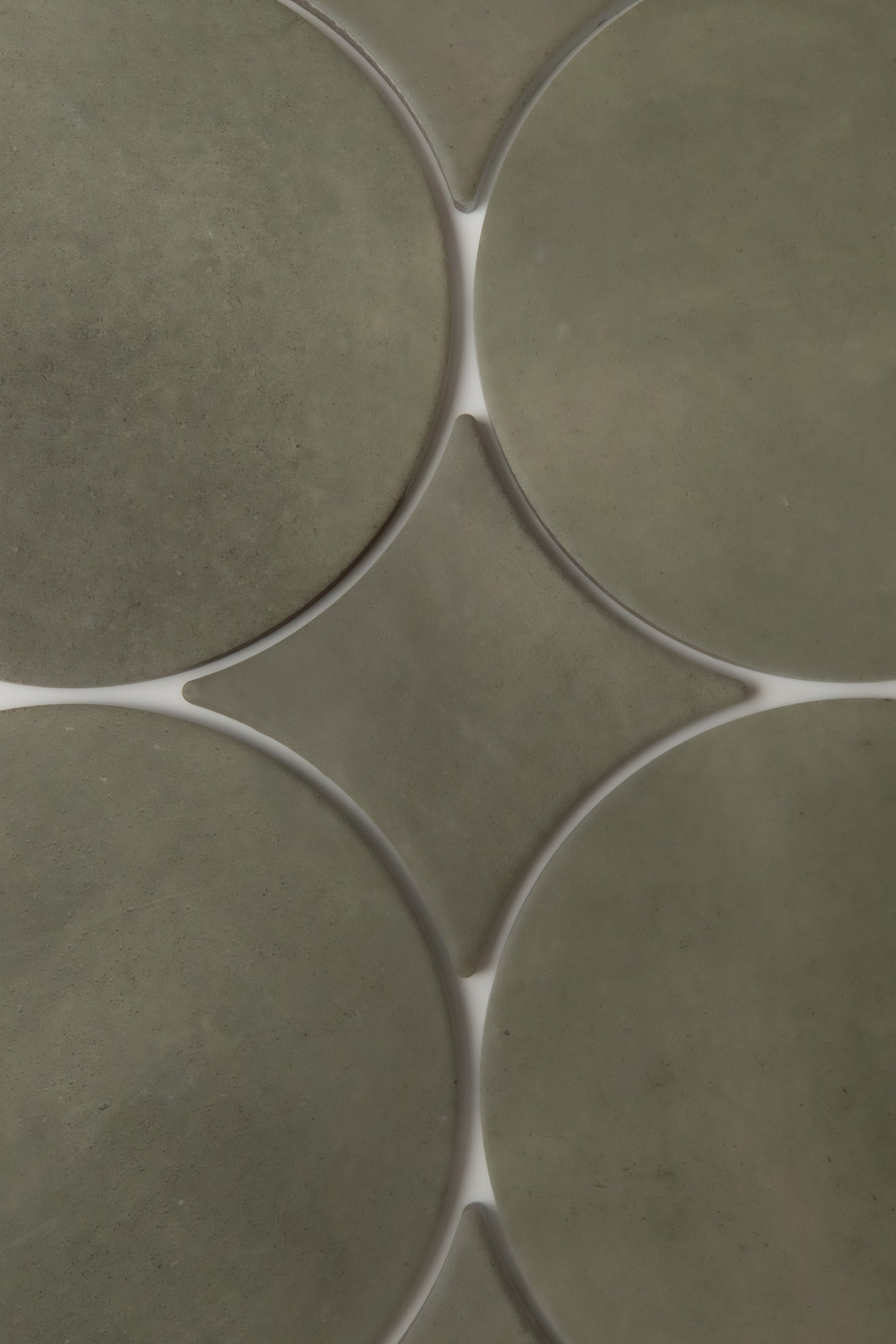 A close-up of Finca's Cardon tiles in olive green, with white grout creating a geometric, diamond pattern at intersections.