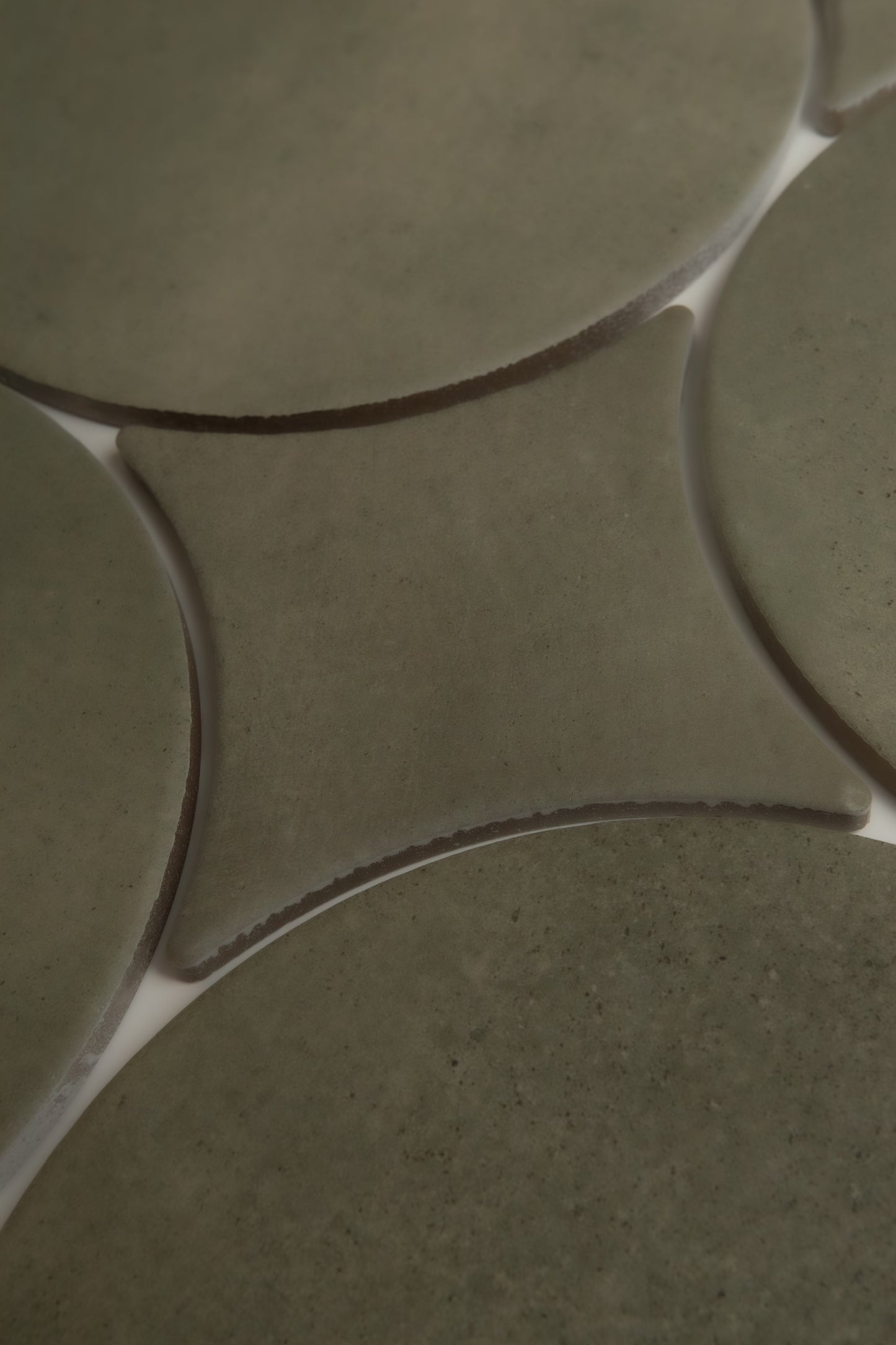 Close-up of Finca's Cardon Sample: greenish curved ceramic tiles with white grout forming star-like intersections.