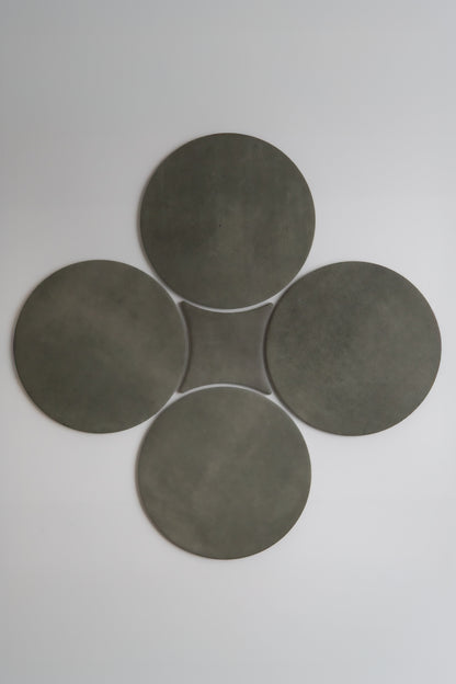 Four dark gray circles in a clover pattern on light backdrop. Product: Cardon, Sample by Finca.