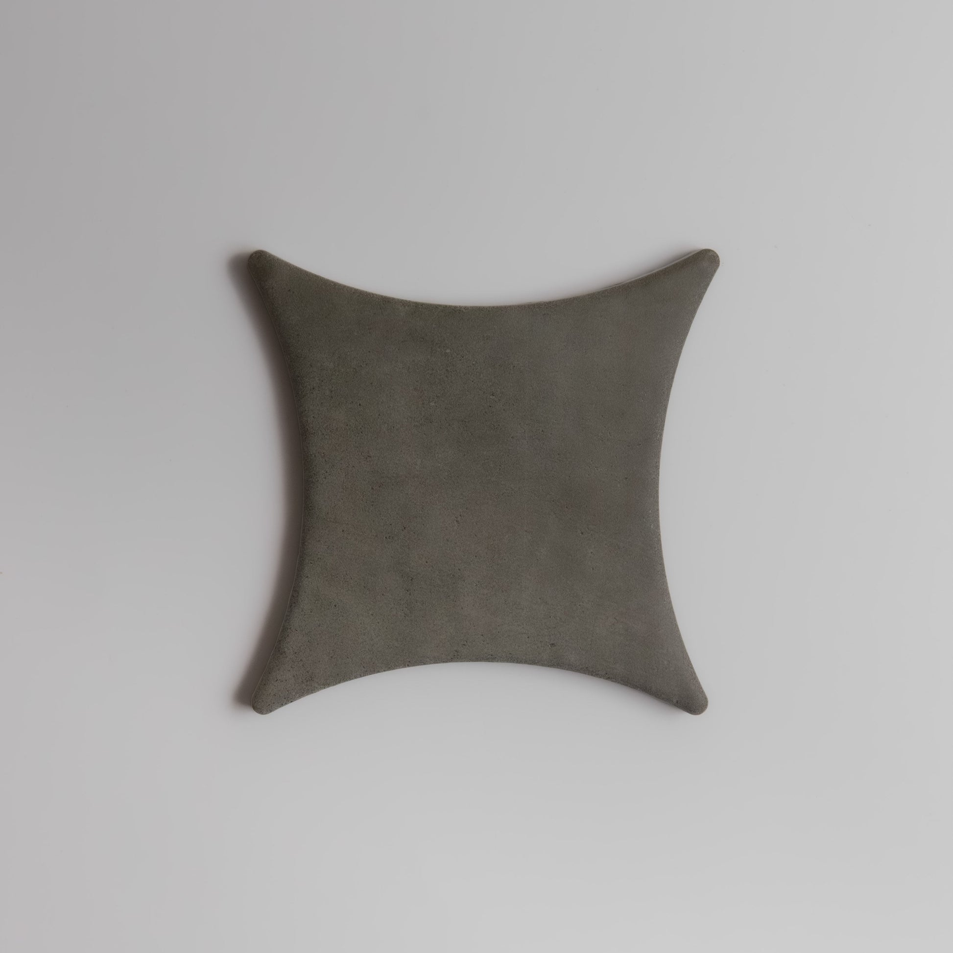 The Finca Cardon Sample is a dark gray, square object with concave sides on a plain white background.
