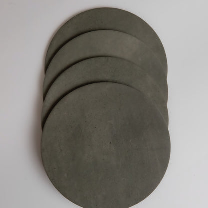 Four round, flat gray Cardon disks by Finca overlap each other on a white background.