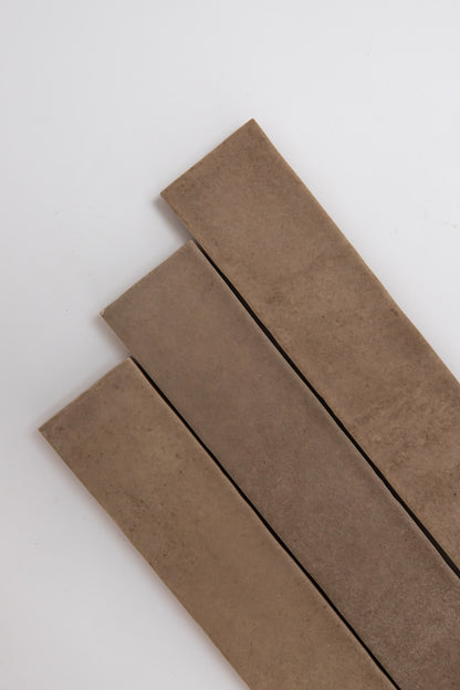 Three Castlegate Brown strips by Cottage Ivy, arranged diagonally on a white background.
