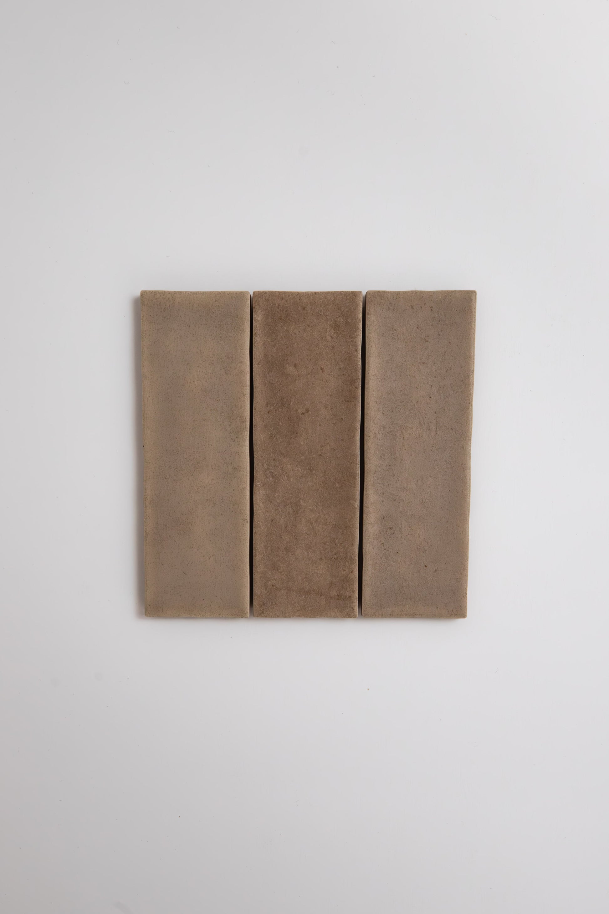 Three Castlegate Brown tiles by Cottage Ivy are arranged vertically side by side on a plain white background.