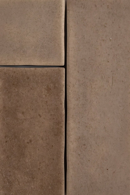 Close-up of Castlegate Brown tiles by Cottage Ivy, showing textured surface, visible seams, and subtle variations.