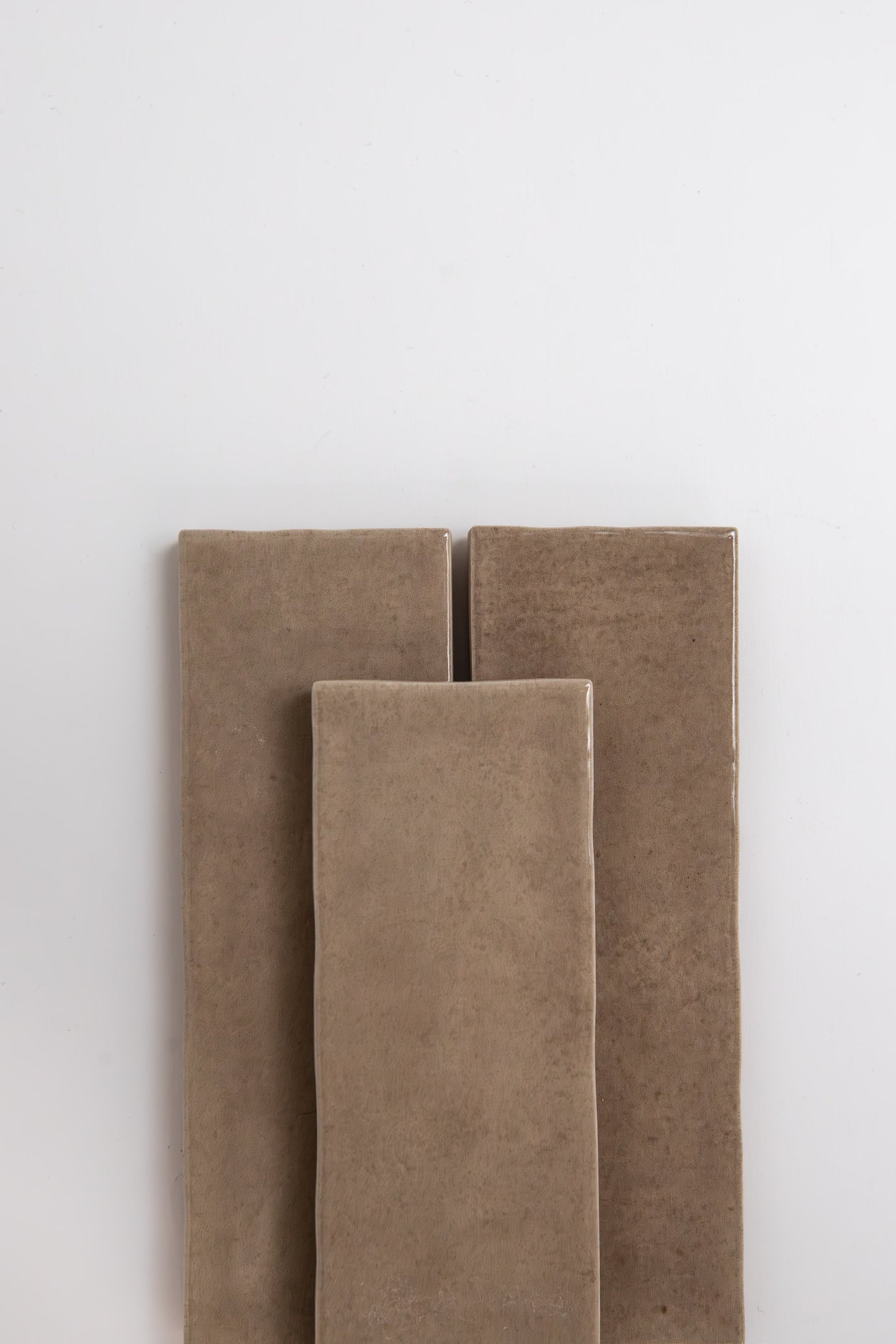 Three Castlegate Brown samples by Cottage Ivy are standing upright against a plain white background.