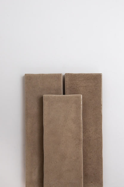 Three Castlegate Brown samples by Cottage Ivy are standing upright against a plain white background.