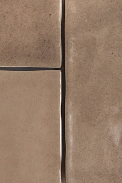 Four Castlegate Brown tiles by Cottage Ivy, tan with uneven edges, are arranged together, showing slight gaps.