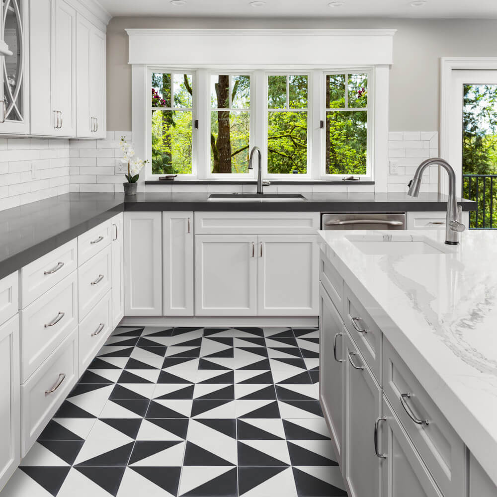 Modern kitchen features New York Cement Tile’s N20-139 Black & White sample, sleek cabinets, and large windows.