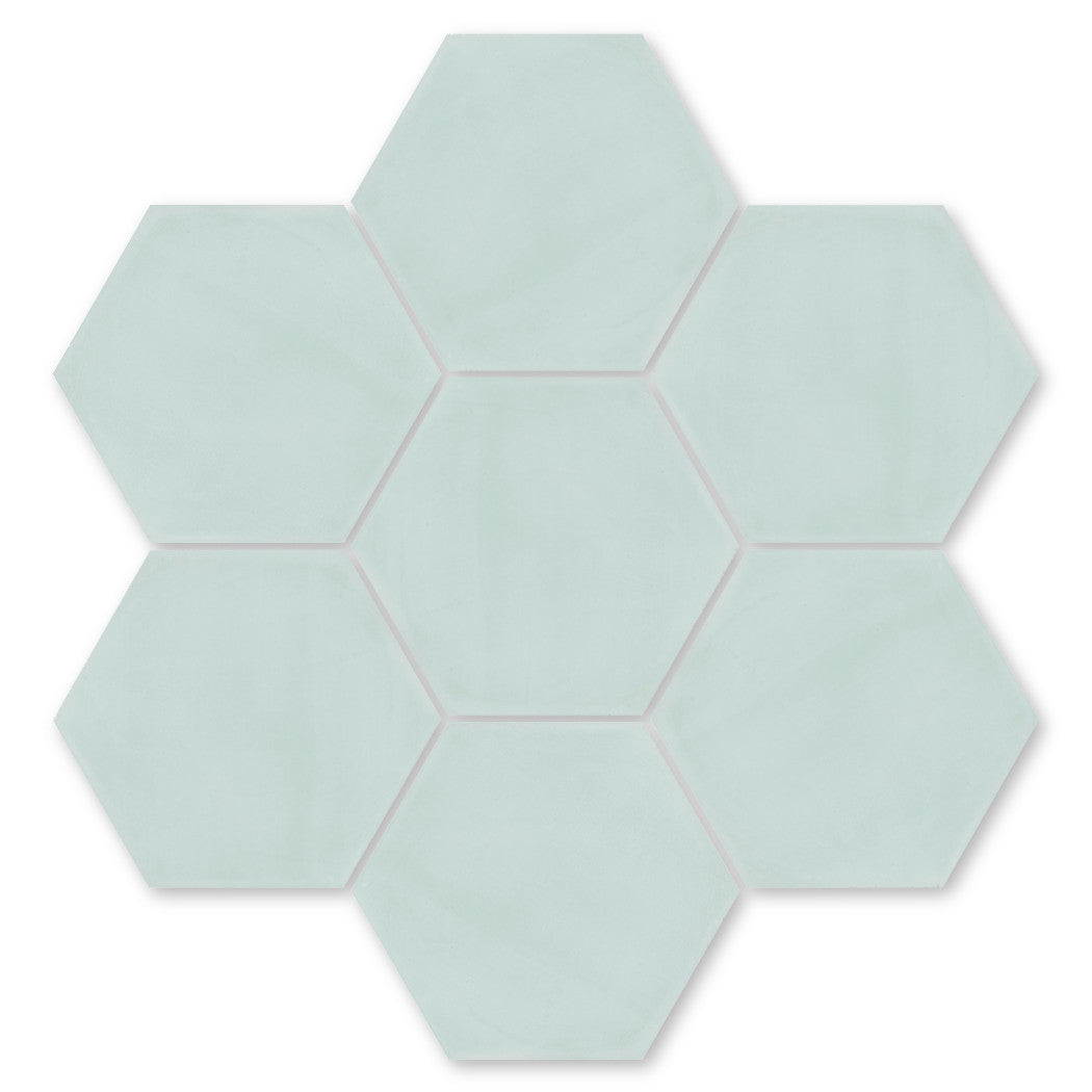 Seven Solid Hex- Whisper tiles by New York Cement Tile, pale blue, in a honeycomb pattern on a white background.
