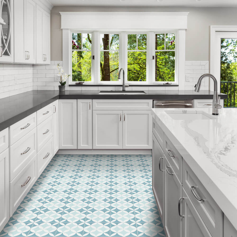Bright kitchen featuring New York Cement Tile's N20-062 4400/2 blue-and-white cement tile floor and large windows.
