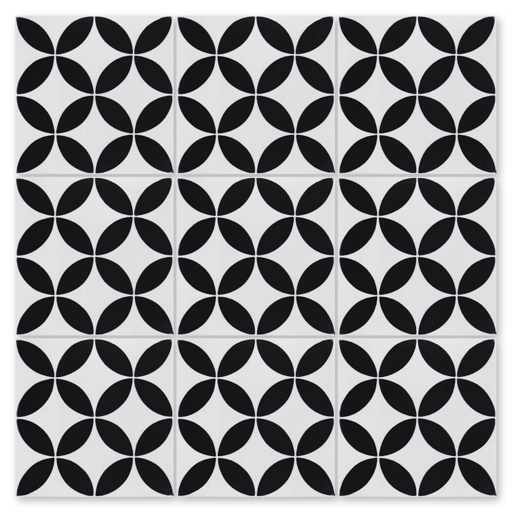 The N20-061 White, Sample by New York Cement Tile features black and white interlocking circles and petal-like shapes.