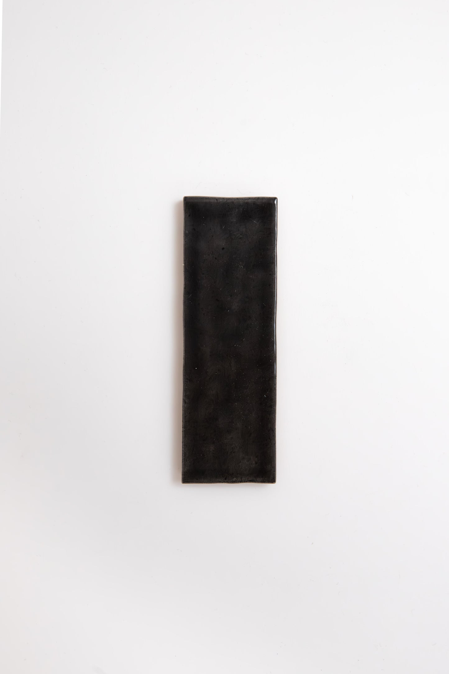 A Cobbled Graphite tile by Cottage Ivy is centered on a plain white background.