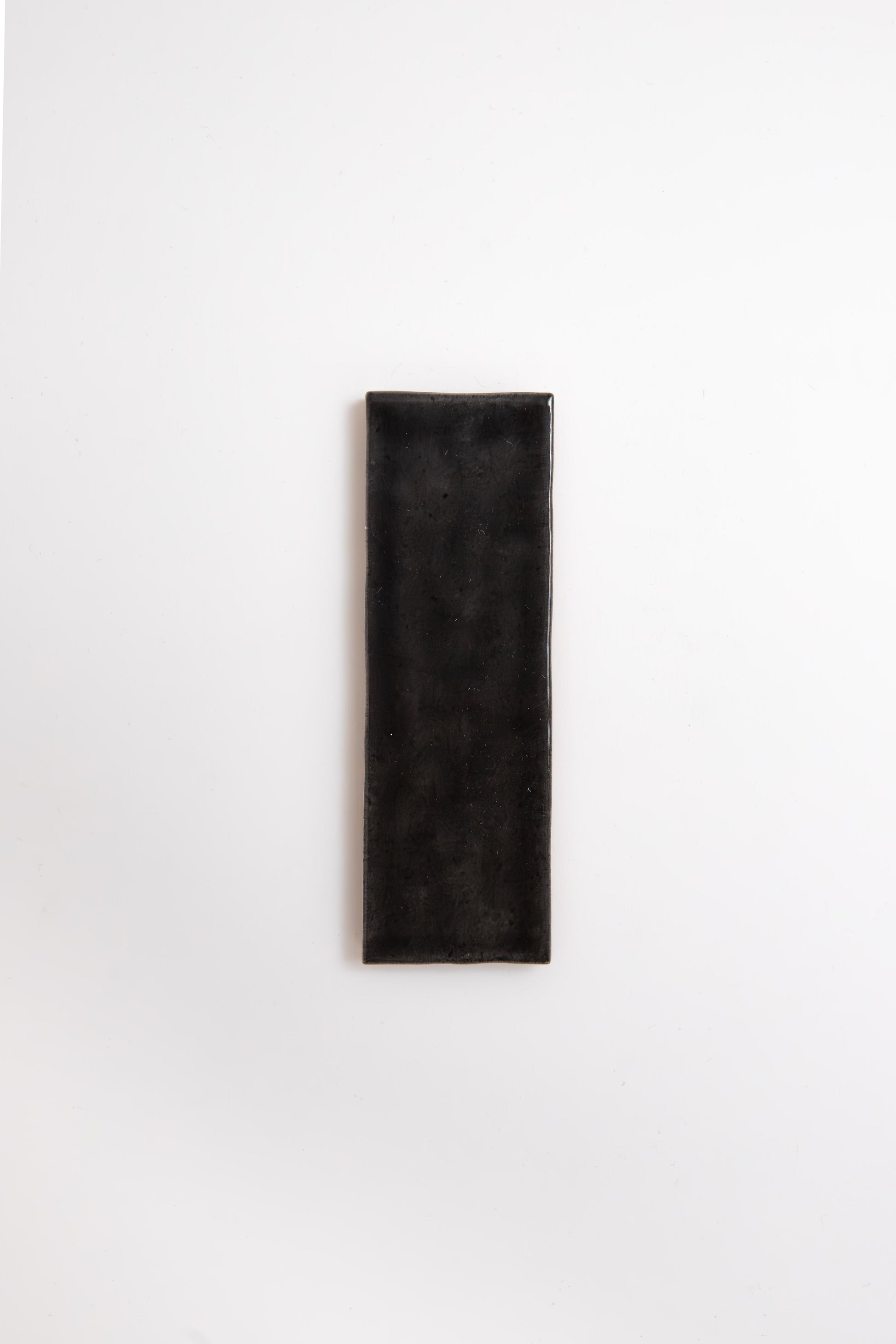 A Cobbled Graphite tile by Cottage Ivy is centered on a plain white background.